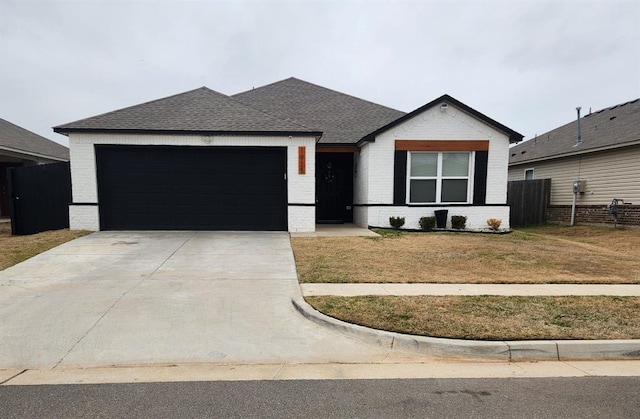 single story home featuring a garage and a front lawn