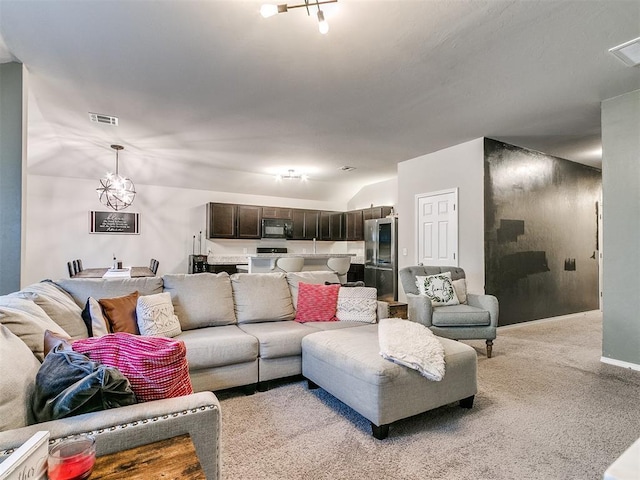 carpeted living room featuring a notable chandelier