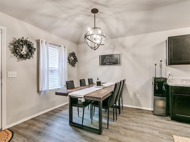 dining room featuring light hardwood / wood-style flooring and an inviting chandelier