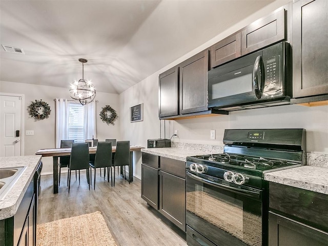 kitchen featuring black appliances, decorative light fixtures, light wood-type flooring, a notable chandelier, and dark brown cabinetry