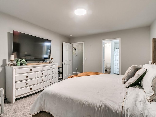 bedroom featuring light colored carpet and connected bathroom