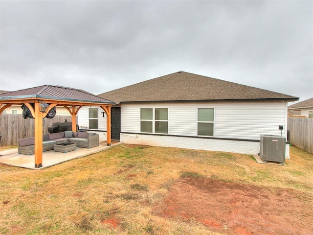 back of house featuring a lawn, outdoor lounge area, central air condition unit, a gazebo, and a patio area