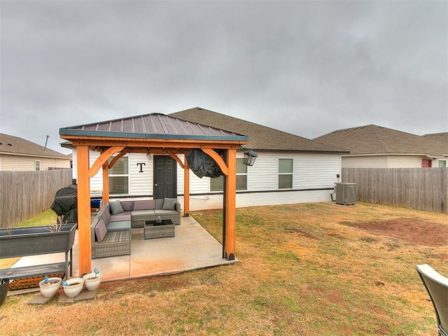 rear view of house featuring outdoor lounge area, central air condition unit, a gazebo, a yard, and a patio