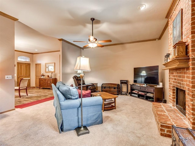 living room with ceiling fan, a fireplace, ornamental molding, and carpet flooring