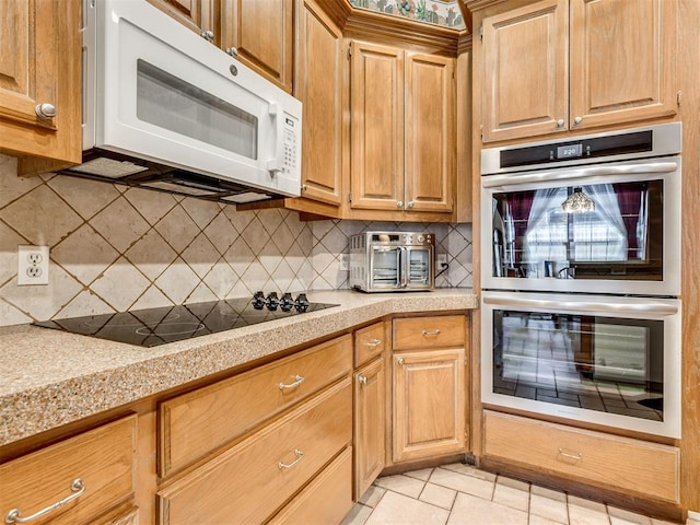 kitchen with black electric cooktop, light tile patterned flooring, double oven, and decorative backsplash