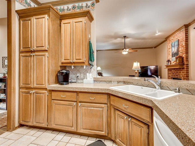 kitchen with ceiling fan, dishwashing machine, sink, and backsplash