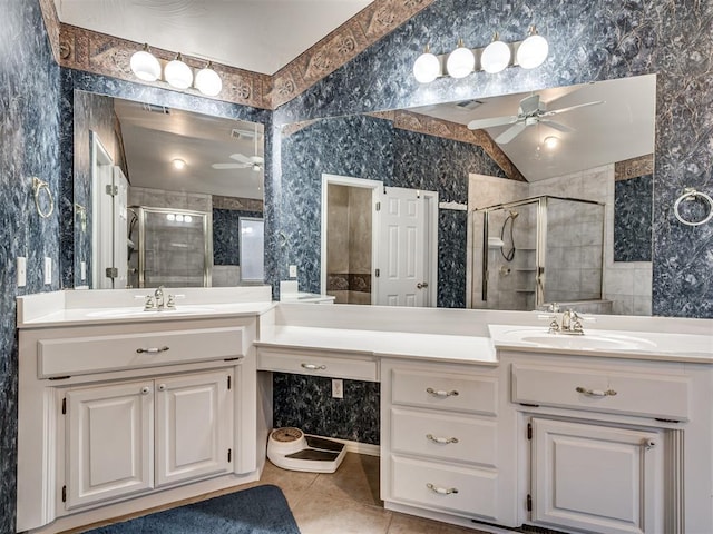 bathroom featuring vanity, lofted ceiling, ceiling fan, and walk in shower