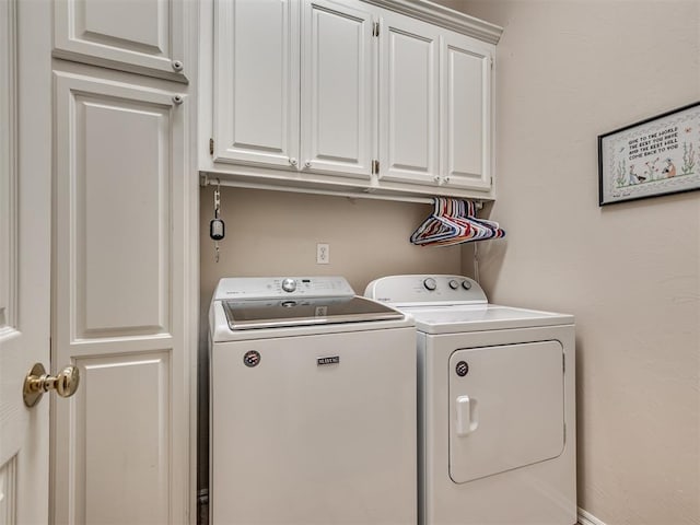 laundry room with cabinets and washer and dryer