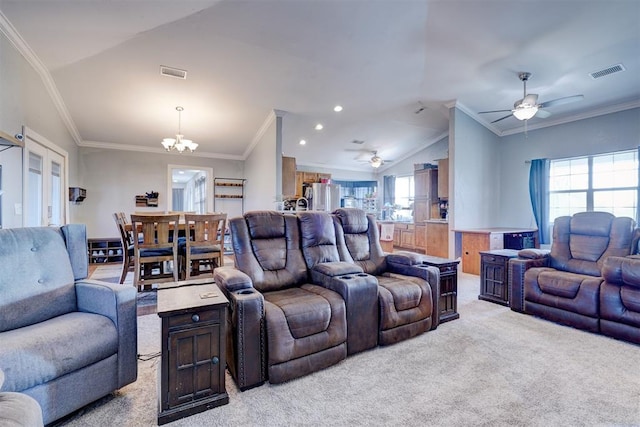 carpeted living room featuring a wealth of natural light, ceiling fan with notable chandelier, lofted ceiling, and ornamental molding