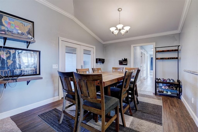 dining area featuring ornamental molding, dark hardwood / wood-style flooring, and lofted ceiling