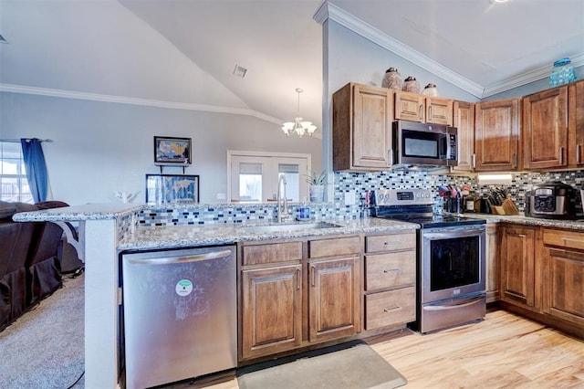 kitchen featuring sink, lofted ceiling, stainless steel appliances, and tasteful backsplash