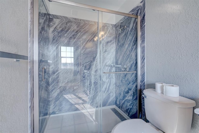 bathroom with an enclosed shower and toilet