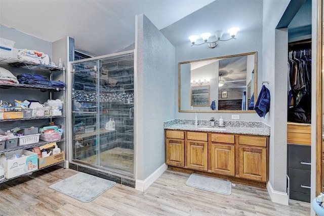 bathroom with vanity, hardwood / wood-style flooring, and walk in shower