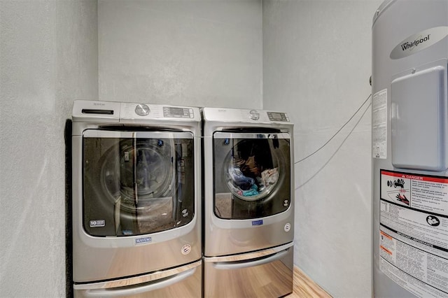 laundry area featuring washing machine and dryer and electric water heater