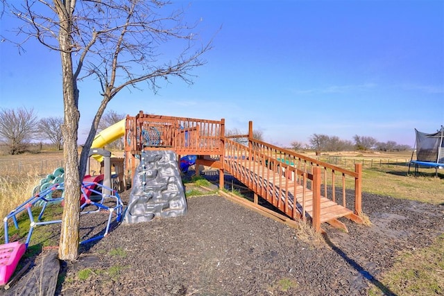 view of play area with a rural view and a trampoline