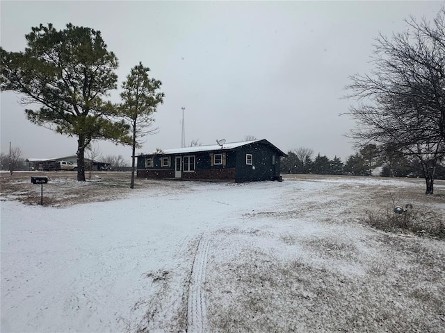 view of snow covered back of property