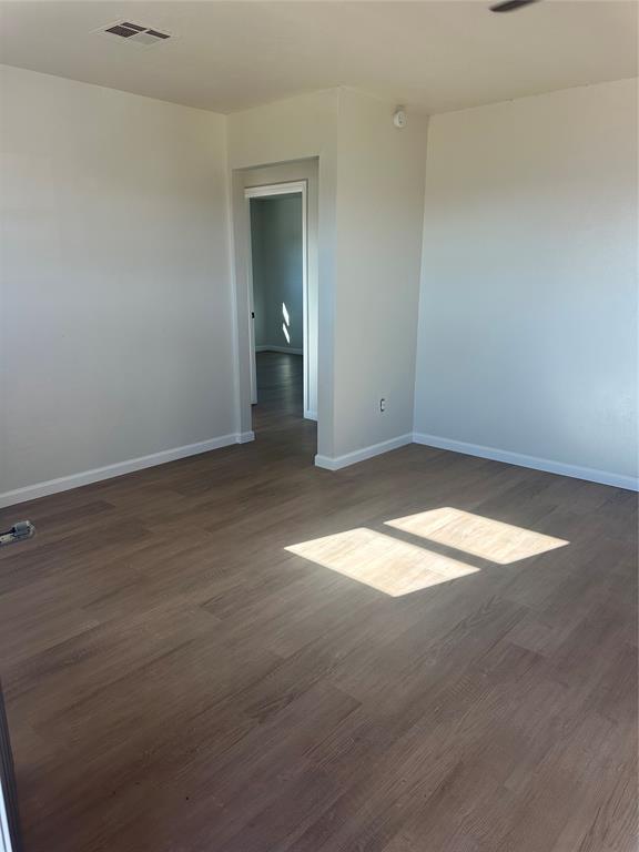 spare room featuring dark hardwood / wood-style flooring