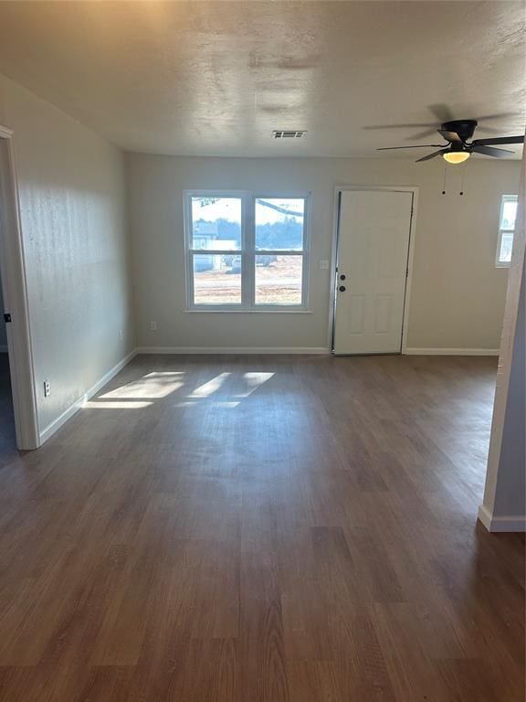 interior space with ceiling fan and dark hardwood / wood-style floors