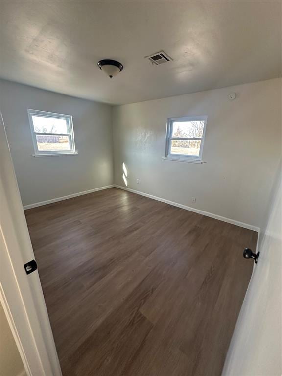 spare room with dark hardwood / wood-style flooring