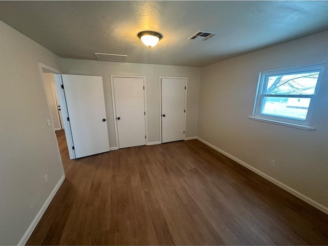 unfurnished bedroom with hardwood / wood-style floors