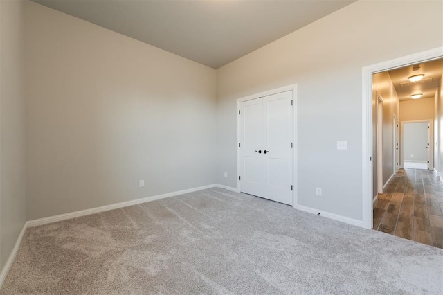 unfurnished bedroom with carpet flooring and a closet