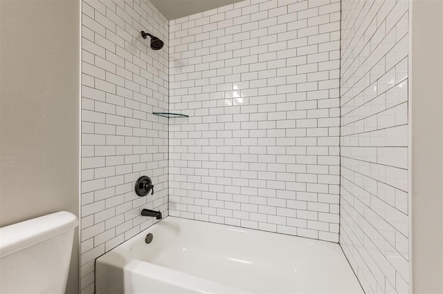 bathroom featuring shower / bathing tub combination and toilet