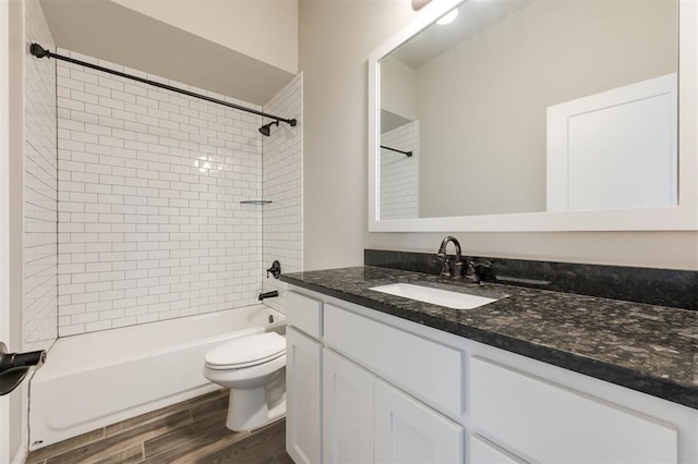 full bathroom featuring toilet, shower / tub combination, wood finished floors, and vanity