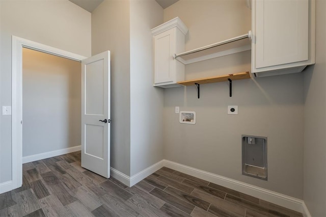 laundry room with electric dryer hookup, hookup for a washing machine, dark hardwood / wood-style flooring, and cabinets