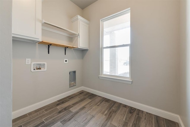 laundry room with dark wood-type flooring, cabinets, hookup for a washing machine, and electric dryer hookup