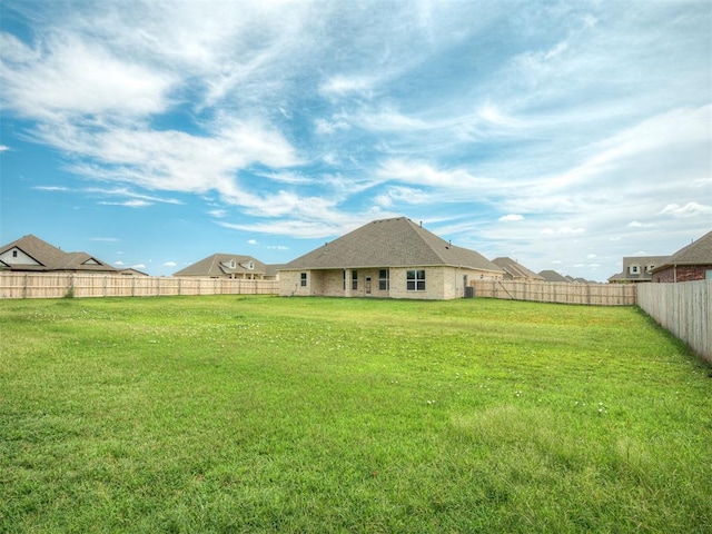 view of yard with a fenced backyard