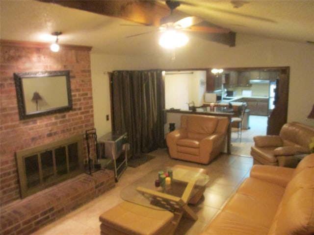 living room featuring ceiling fan, a fireplace, light tile patterned floors, and lofted ceiling