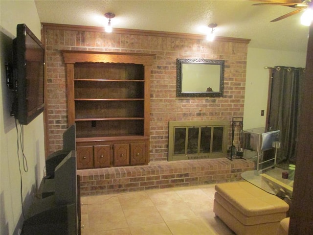 living room featuring ceiling fan, a fireplace, light tile patterned flooring, and built in features