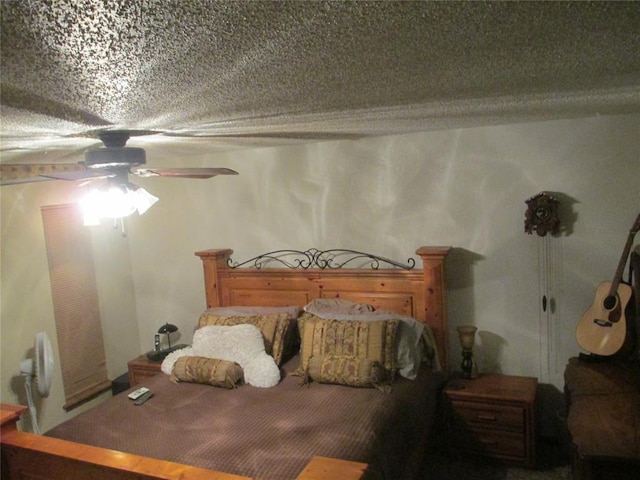 bedroom with ceiling fan and a textured ceiling