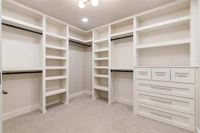 spacious closet featuring light carpet