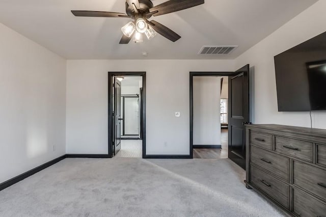 unfurnished bedroom with ceiling fan and light colored carpet