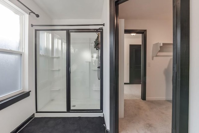 bathroom with a wealth of natural light and a shower with door