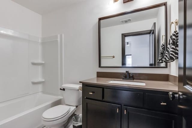 full bathroom featuring washtub / shower combination, vanity, and toilet