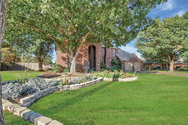 view of front facade with a garage and a front yard