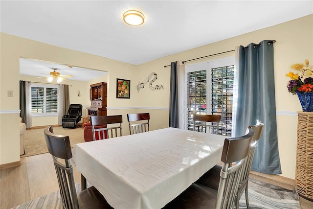 dining room with plenty of natural light, light hardwood / wood-style floors, and ceiling fan