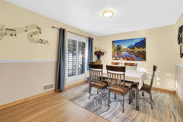 dining area with hardwood / wood-style flooring