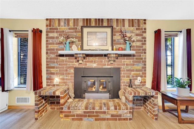 room details featuring hardwood / wood-style flooring and a brick fireplace