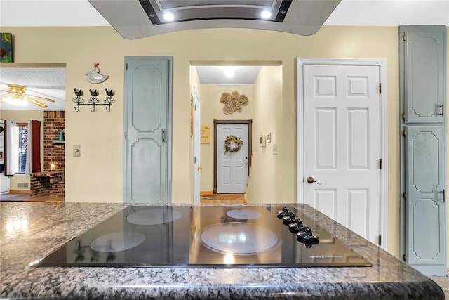 kitchen with black electric stovetop and ceiling fan