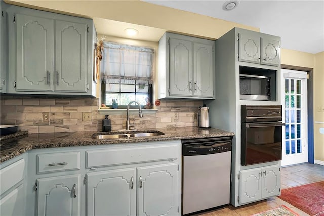 kitchen with light tile patterned flooring, tasteful backsplash, sink, oven, and stainless steel dishwasher