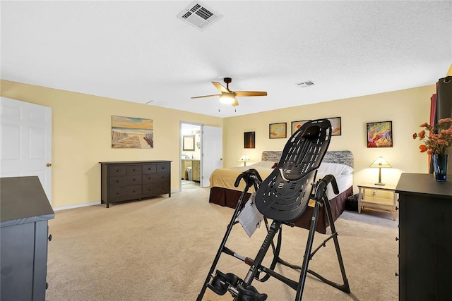 carpeted bedroom with connected bathroom, a textured ceiling, and ceiling fan