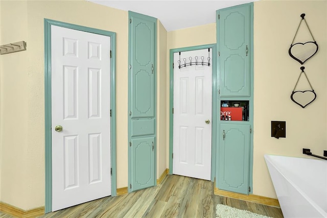 interior space featuring hardwood / wood-style flooring and a tub