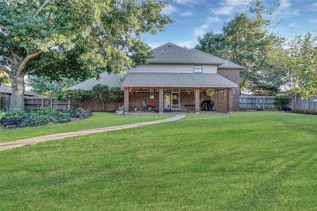 back of property featuring a yard and a patio