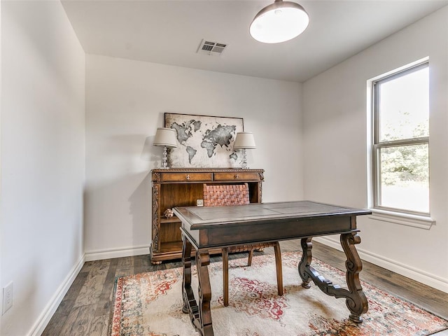 home office with dark hardwood / wood-style floors