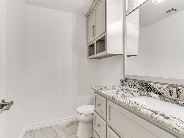 bathroom with vanity and toilet