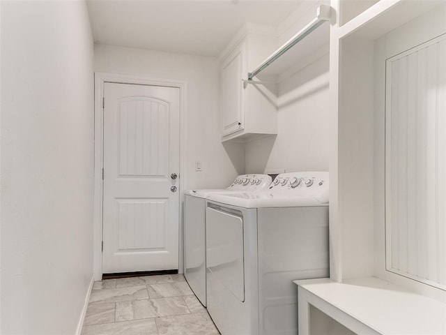 washroom featuring cabinets and washer and dryer