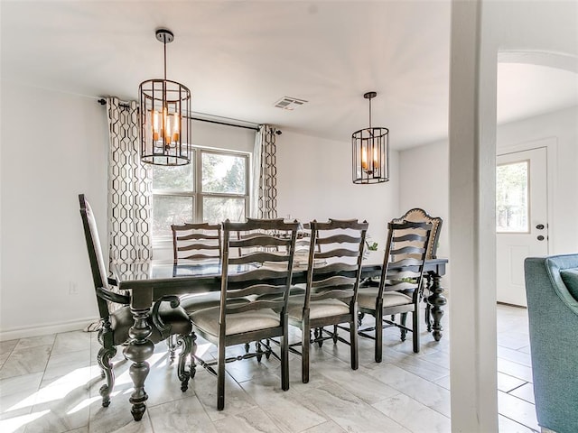 dining space featuring a notable chandelier and plenty of natural light